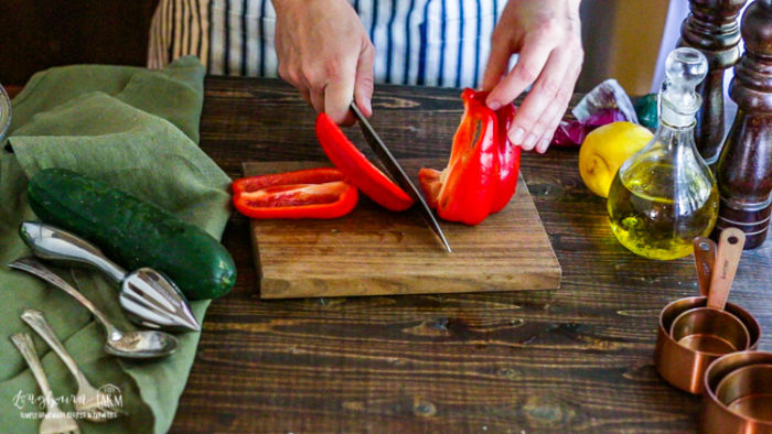 Slicing a bell pepper on a cutting board. 