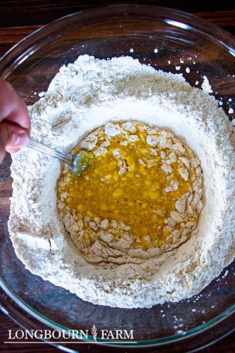 mixing the eggs into the flour with a fork