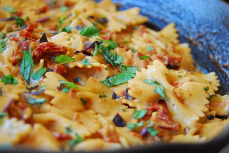 Close-up view of skillet sun dried tomato pasta.