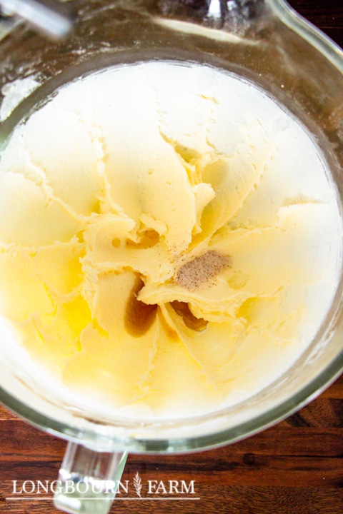 creamed butter and sugar in a mixing bowl with vanilla added