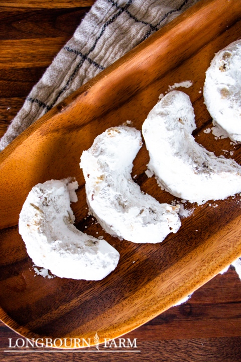 crescent shaped cookies covered in powdered sugar