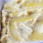 Make ahead mashed potatoes topped with melted butter.
