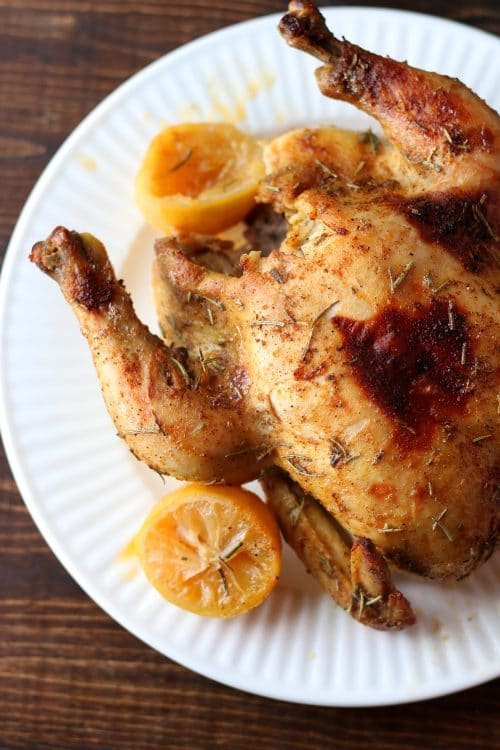 Cooked rotisserie chicken on a plate.