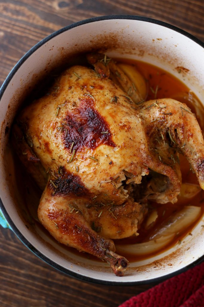 Cooked rotisserie chicken in a pot.