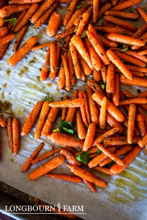brown sugar carrots on a parchment lined baking sheet