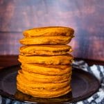 side view of a orange stack of pumpkin pancakes