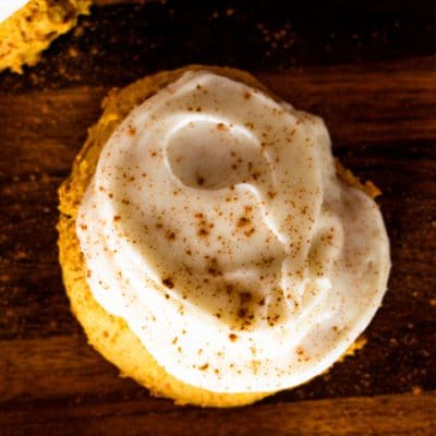 frosted pumpkin sugar cookie with sprinkled cinnamon