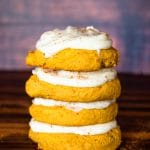 stack of frosted soft pumpkin sugar cookies
