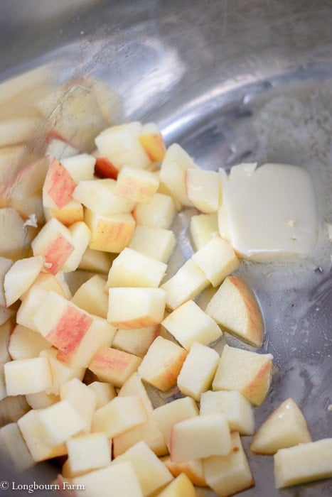 Chopped apples with butter sautéing in an instant pot.