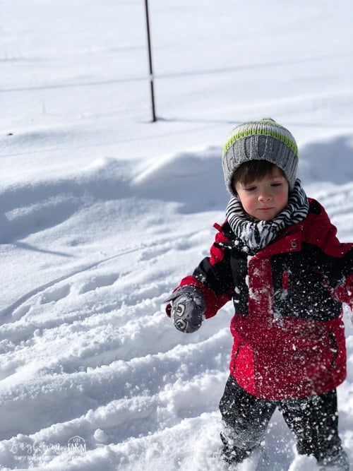 Abram playing outside in the deep snow.