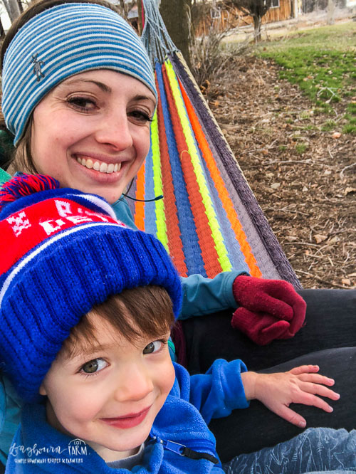 Mommy and Abram sitting in the hammock.