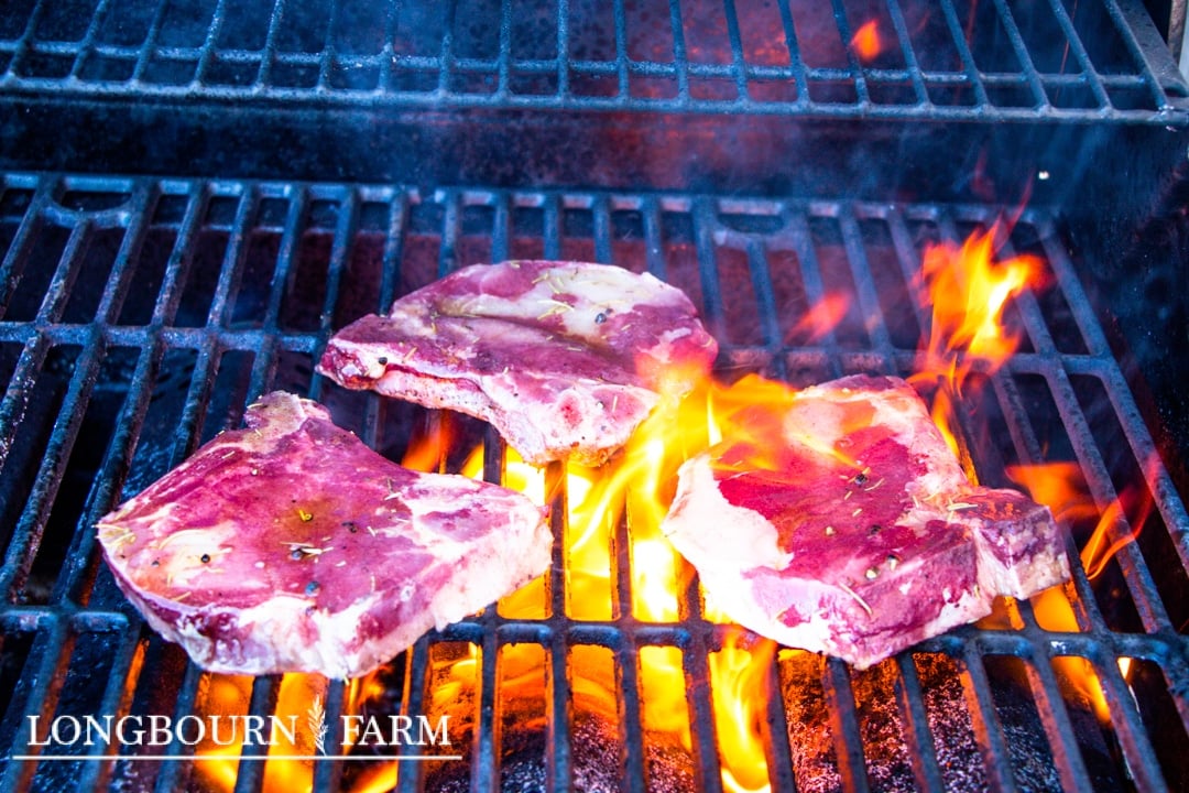 flamesunder pork chops on a grill