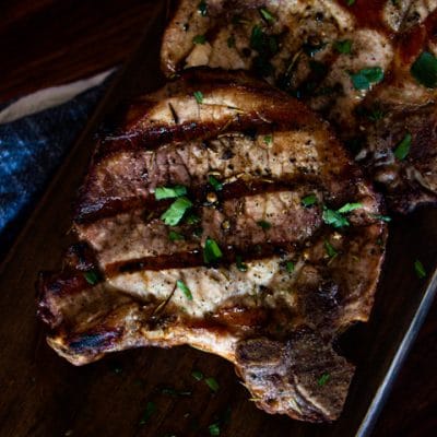 grilled pork chops on a cutting board