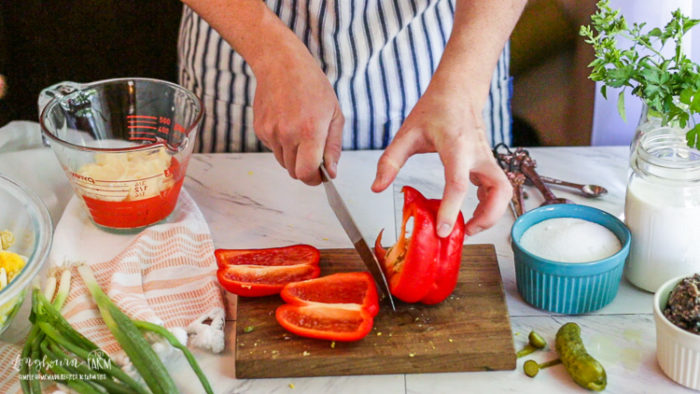 Slicing a red bell pepper.