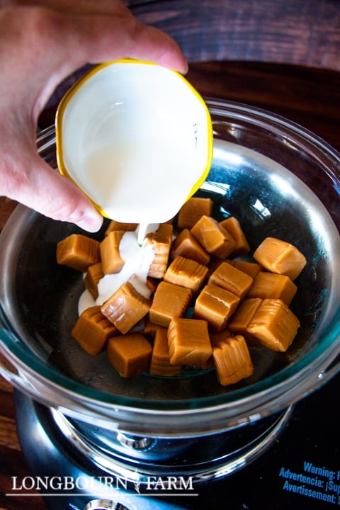 adding cream to a bowl of caramel