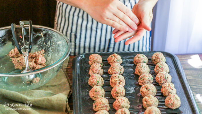 Rolling meatballs for homemade Italian meatballs.