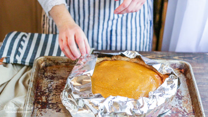 Baked homemade pumpkin pie with crust covered. 