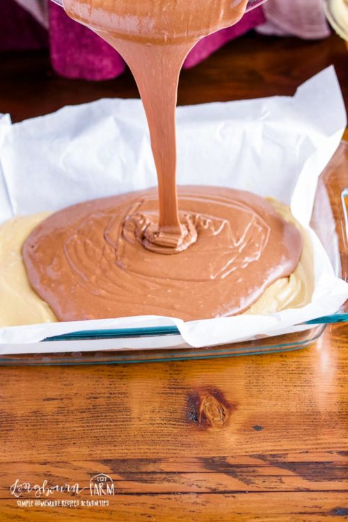 Pouring peanut butter chocolate fudge into pan. 