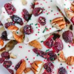 White chocolate Christmas bark is an incredibly easy dessert to whip up for guests or a family treat! It's festive colors make it a holiday favorite. #whitechocolate #whitechocolatebark #whitechocolatebarkrecipes #whitechocolatebarkchristmas #christmasbark #christmasbarkeasy #christmasbarkrecipes