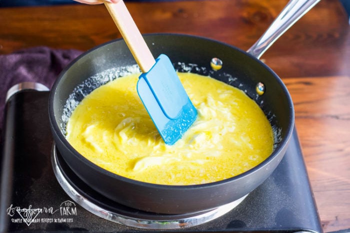 Using a nonstick pan and rubber spatula to cook scrambled eggs. 