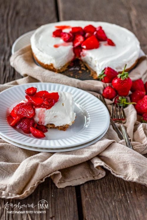 Homemade no-bake cheesecake sliced on a plate and on a platter.