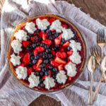 Triple berry pie is a delicious no-bake summer dessert that everyone will love! Tart, sweet, and perfectly paired with a crunchy graham cracker crust. #tripleberrypie #tripleberrypiefilling #tripleberrypierecipe #tripleberrypieeasy #berrypie #berrypiefilling #berrypierecipe #grahamcrackercrust