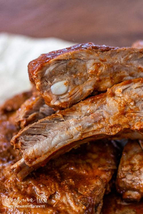 Sliced slow cooker pork ribs on a cutting board. 