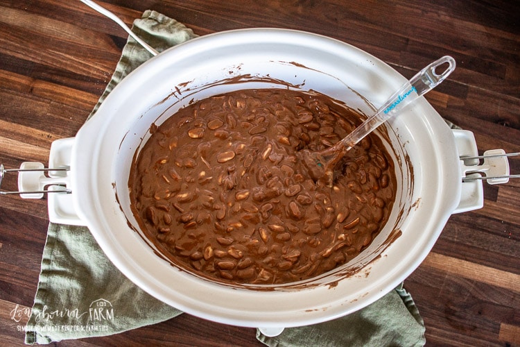 a crockpot full of peanuts and melted chocolate