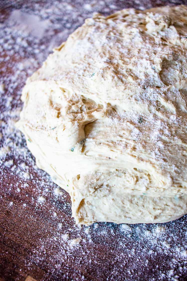rolling the potato bread dough onto a floured surface