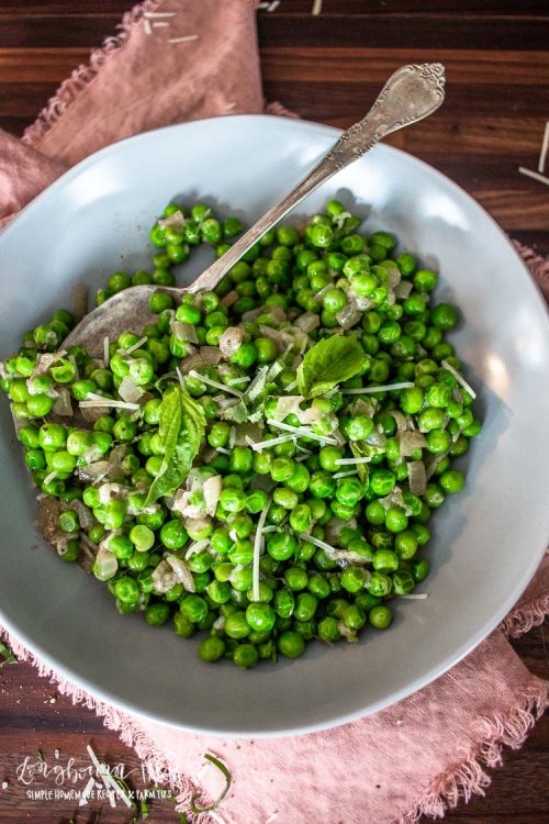 a bowl full of italian peas with a spoon