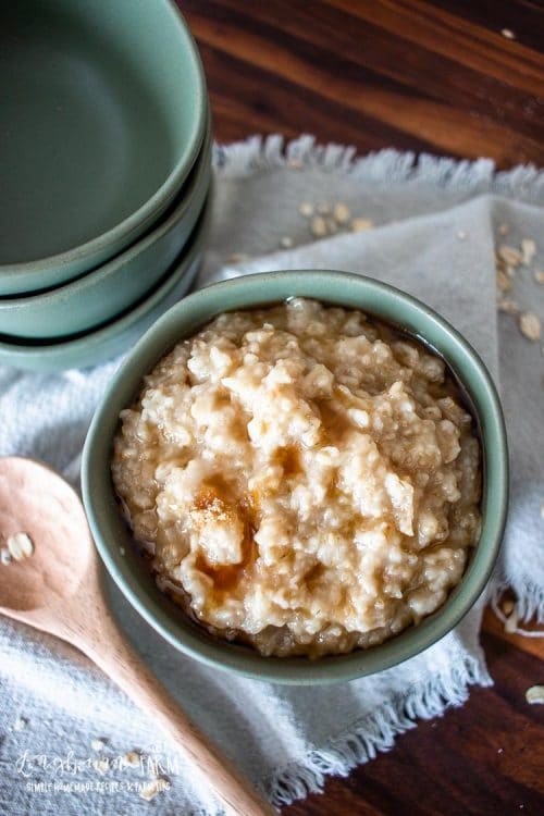 maple and brown sugar oatmeal in a serving bowl topped with more brown sugar and syrup