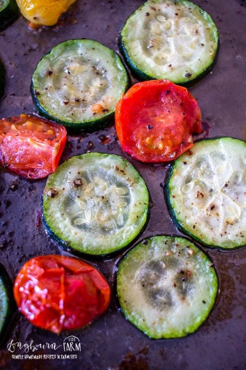 an upclose view of the oven roasted zucchini and tomatoes