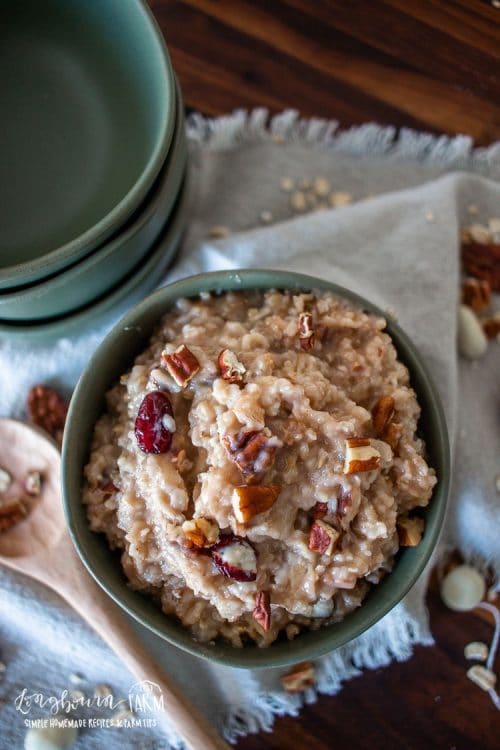 pecan oatmeal in a serving bowl topped with chopped pecans