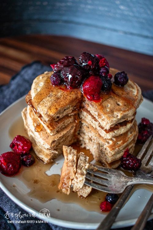 a fork full of whole wheat pancake and a stack behind it