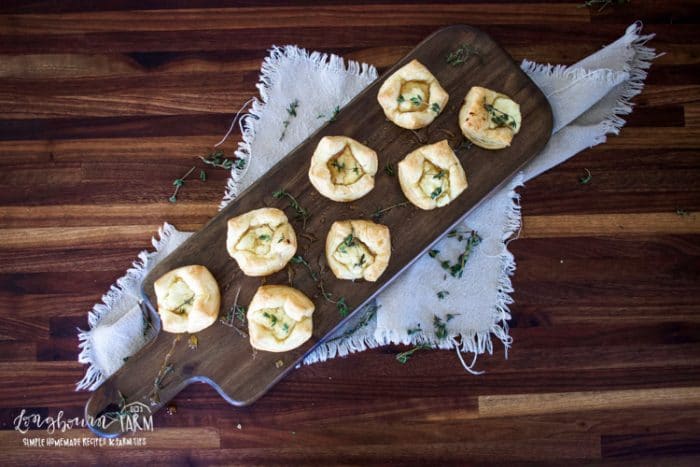 goat cheese honey thyme tarts on a wooden cutting board