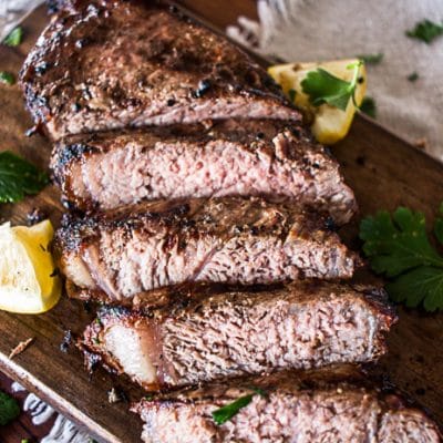 close up view of sliced grilled steak on a cutting board