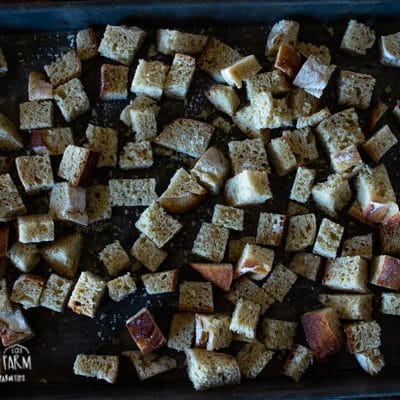 a baking sheet filled with cubed bread