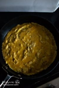 omelet cooking in a skillet aerial view