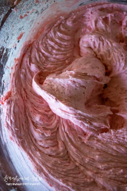 upclose view of fluffy strawberry buttercream in a glass bowl