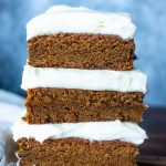 3 sliced pieces of gingerbread cookie bars and whipped frosting