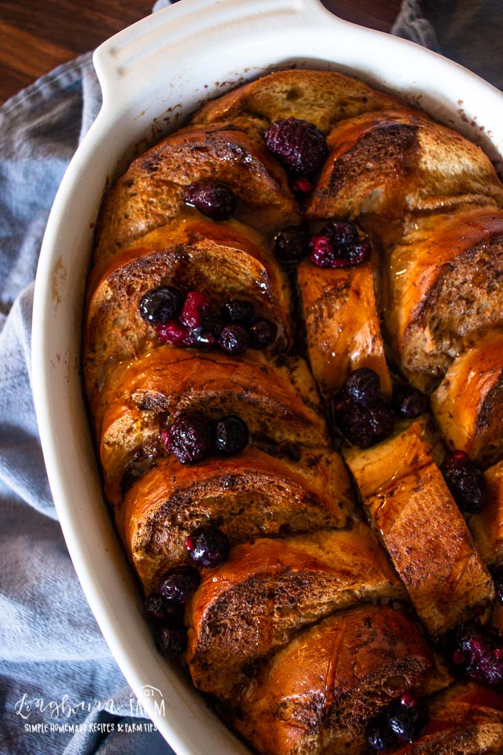 a white baking dish filled with baked blueberry french toast