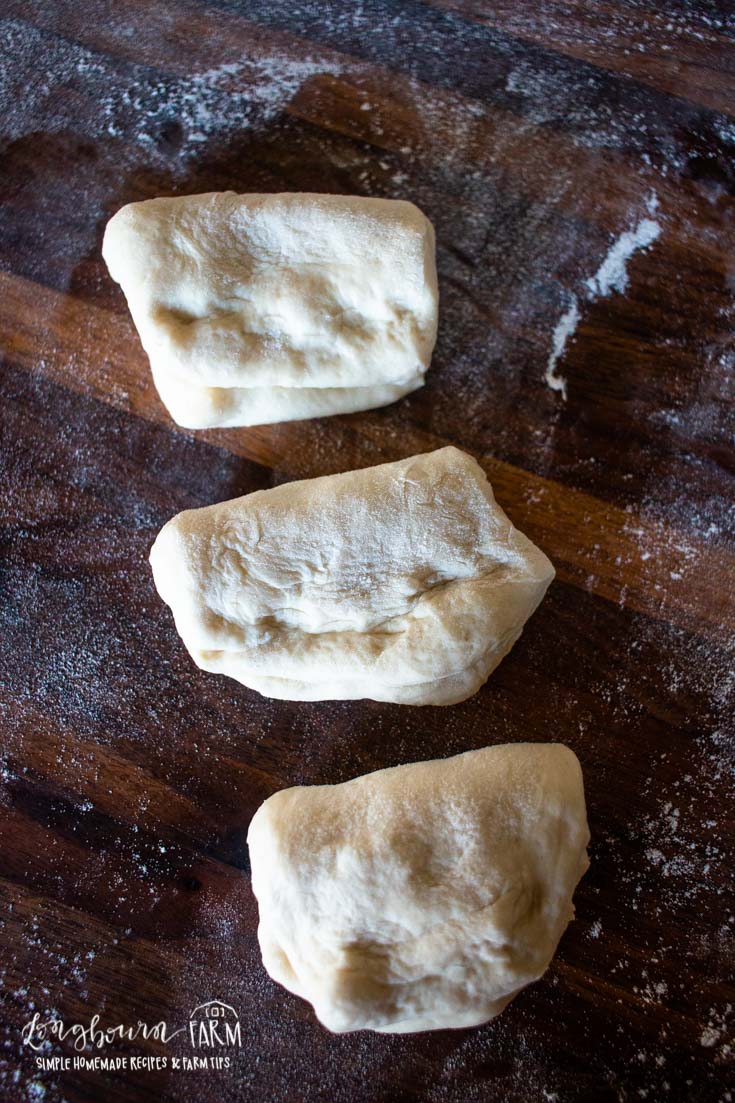 sliced bread roll dough on floured surface