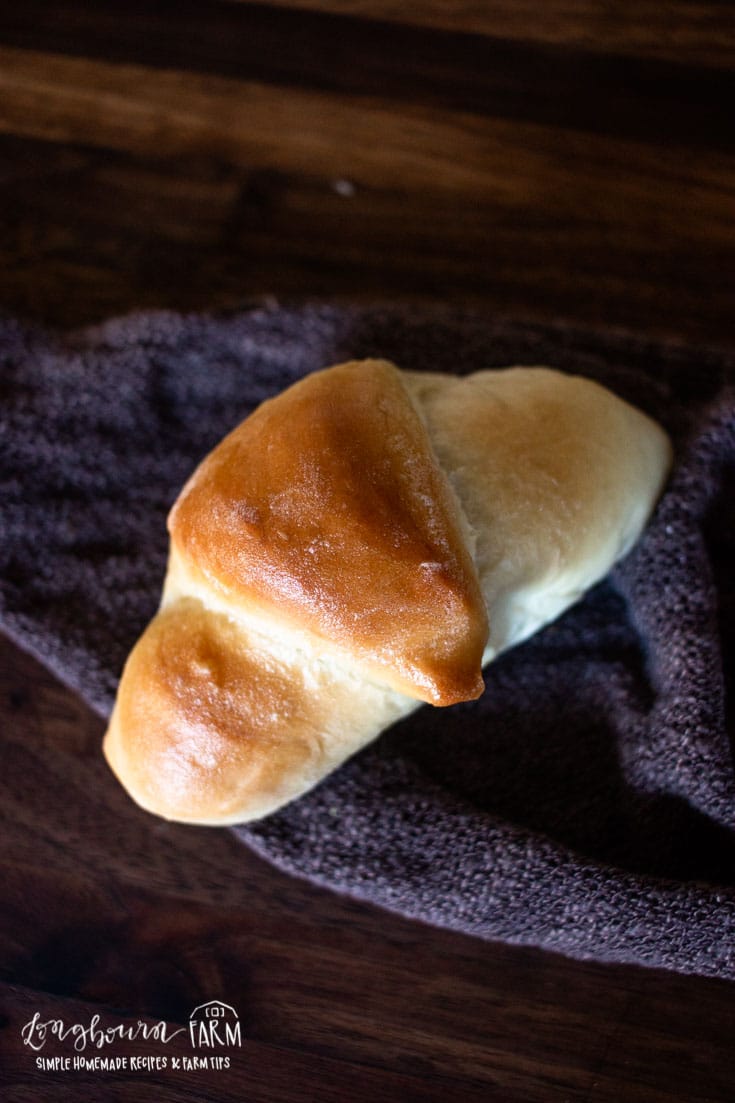 a crescent roll shaped bread roll on cloth