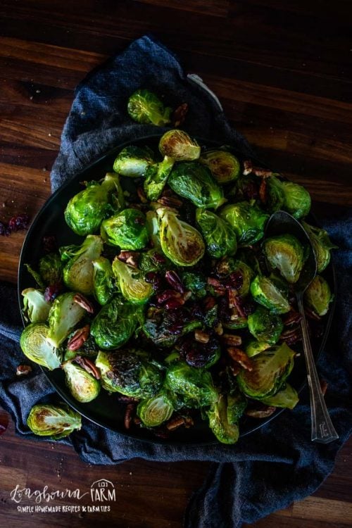 a plate filled with brussel sprouts and a spoon