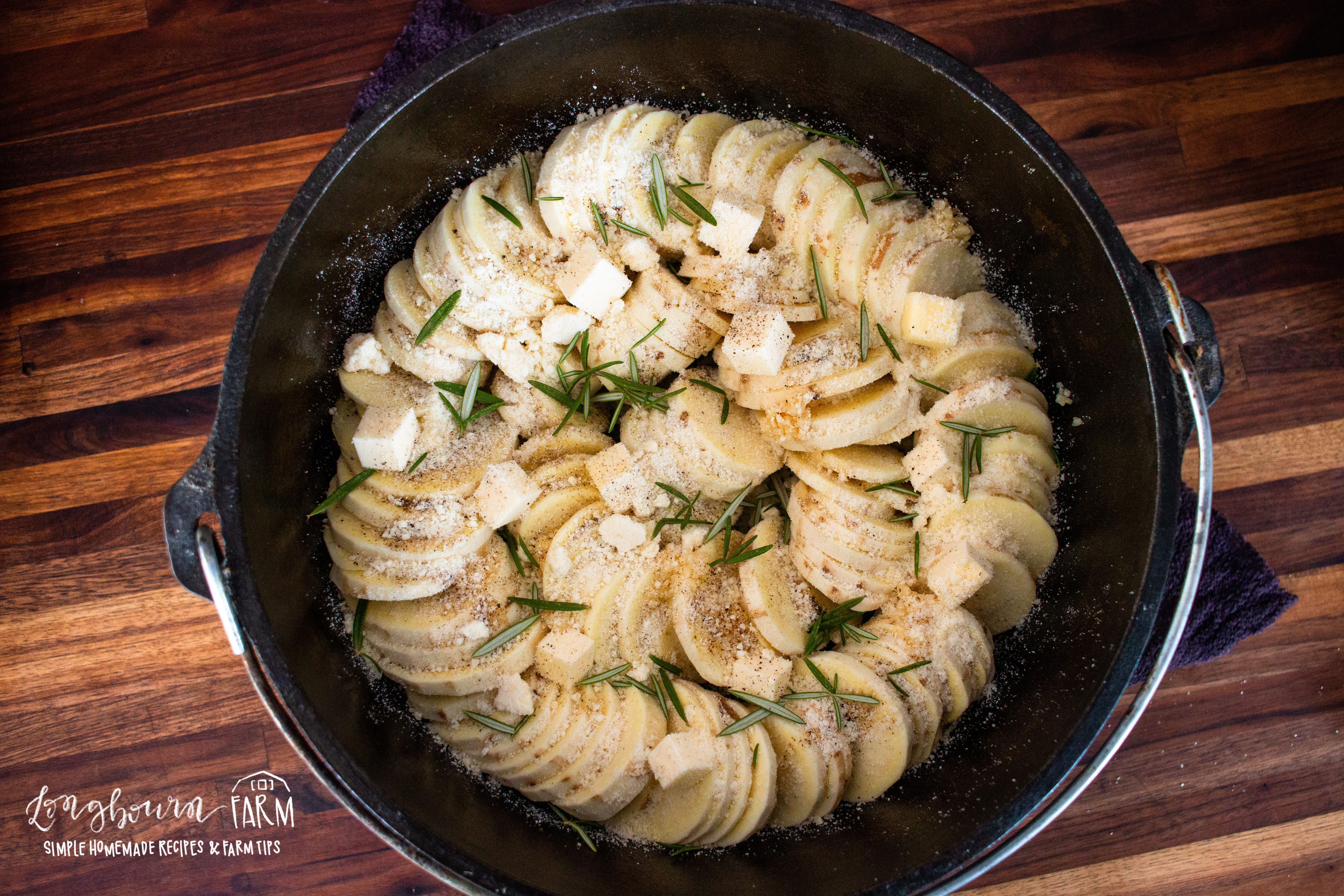 potatoes with herbs arranged in a dutch oven