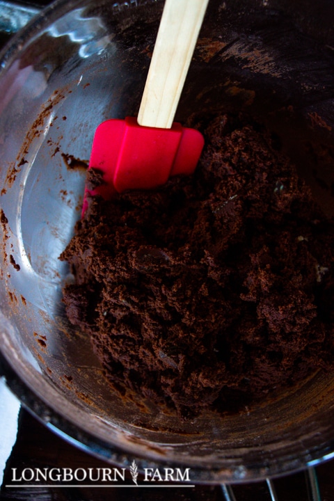 red rubber spatula in bowl of chocolate cookie dough