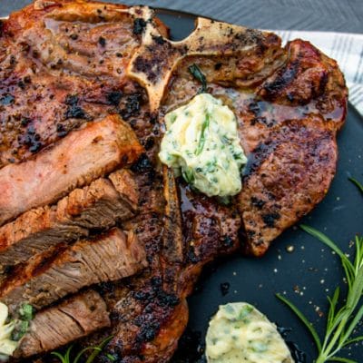 herb butter on a grilled steak with more down belwo