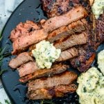 sliced tbone steak with herb butter on top