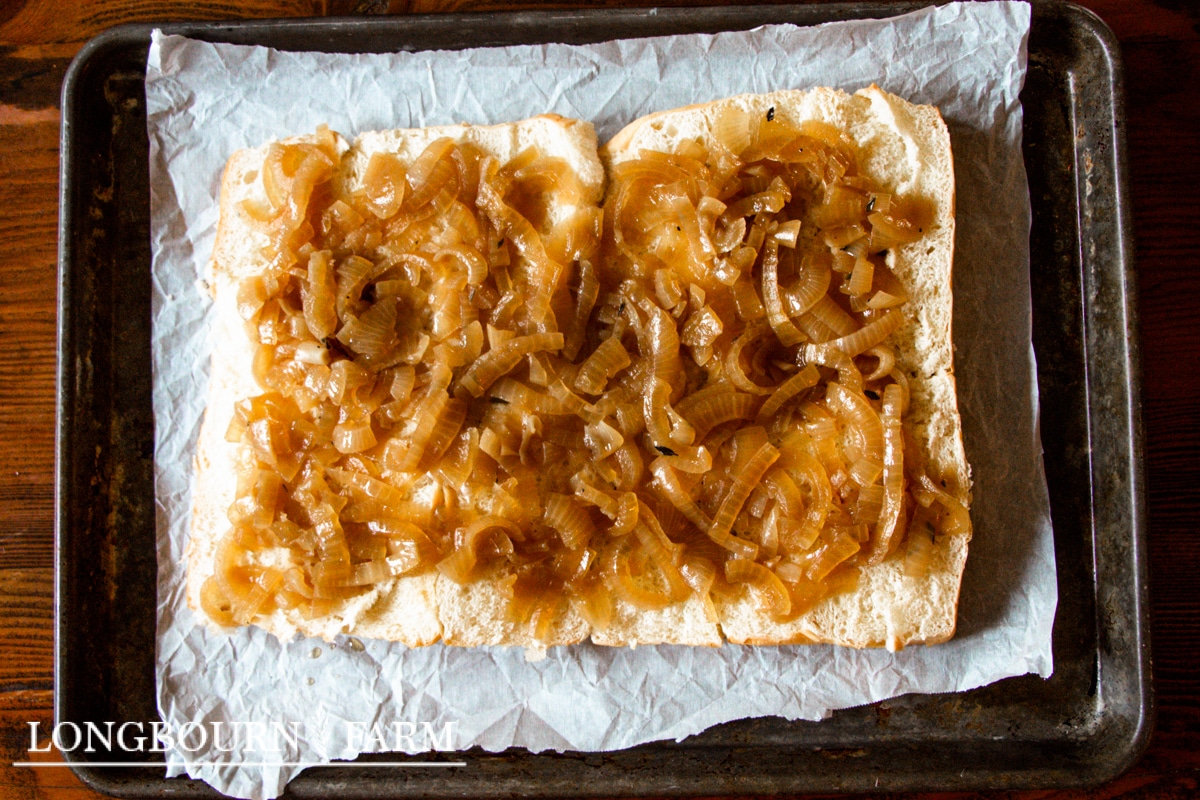 cooked caramelized onions on bread on a baking sheet