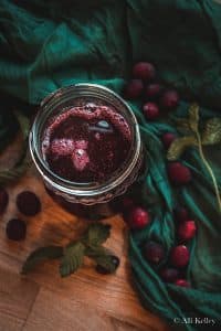 cranberry simple syrup in a glass mason jar